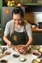 Vietnamese woman in apron serving foor on the table