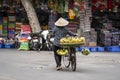 Vietnamese woman with bike selling bananas on the street market of old town in Hanoi, Vietnam Royalty Free Stock Photo