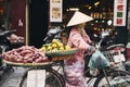 Vietnamese woman with bike selling tropical fruit at the market