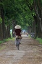 Vietnamese woman cycling on a country road