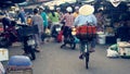 Vietnamese woman cycling at market