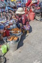 Vietnamese woman eats a tripe dish on the street in Ho CHi Minh City