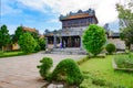 Vietnamese woman explaining buildings in the Citadel, Imperial City Hue, Vietnam, to a tourist.