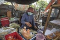 Vietnamese woman makes and sells snacks in a street of Ho Chi Minh City