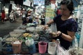 Vietnamese woman making sweet gruel on cart at night food street market