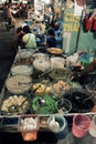 Vietnamese woman making sweet gruel on cart at night food street market