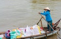 Vietnamese woman rice seller on boat