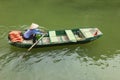 Vietnamese woman rowing boat on river in Trang An travel destination Royalty Free Stock Photo