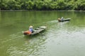 Vietnamese woman rowing boat on river in Trang An travel destination Royalty Free Stock Photo