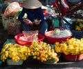 Vietnamese Woman Selling Yellow Chrysanthemums at a Market