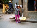 Vietnamese woman with traditional yoke. Hoi An, Vietnam