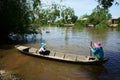 Vietnamese woman transport little girl go to school by wooden boat