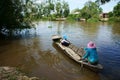 Vietnamese woman transport little girl go to school by wooden boat