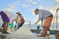 Vietnamese women are burdening hard to collect salt from the extract fields to the storage fields Royalty Free Stock Photo