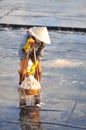 Vietnamese women are burdening hard to collect salt from the extract fields to the storage fields