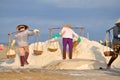 Vietnamese women are burdening hard to collect salt from the extract fields to the storage fields