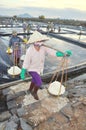 Vietnamese women are burdening hard to collect salt from the extract fields to the storage fields