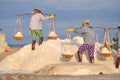 Vietnamese women are burdening hard to collect salt from the extract fields to the storage fields