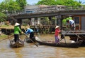 Vietnamese women in traditional boats row and shop near a floating market in Vietnam's Mekong Delta Royalty Free Stock Photo