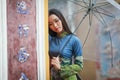 Vietnamese women wear Ao dai holding umbrella in the rain