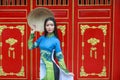 Vietnamese women wear Ao dai and non la