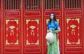 Vietnamese women wear Ao dai and non la