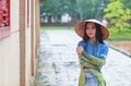 Vietnamese women wear Ao dai in the rain