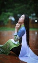 Vietnamese women wear Ao dai in the rain