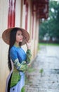 Vietnamese women wear Ao dai in the rain