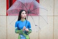 Vietnamese women wear Ao dai in the rain