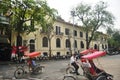 Vietnamese worker people riding biking tricycle rickshaw cart for service travelers travel visit tour Hoan Kiem lake and old town