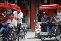 Vietnamese worker people riding biking tricycle rickshaw cart for service travelers travel visit tour Hoan Kiem lake and old town