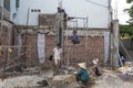 Vietnamese workers build a house