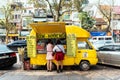 Vietnamese yellow food truck with customers on the street in Hanoi, Vietnam