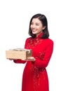 Vietnamese young woman in Ao Dai dress holding gift box. Royalty Free Stock Photo