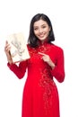 Vietnamese young woman in Ao Dai dress holding gift box. Royalty Free Stock Photo