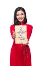 Vietnamese young woman in Ao Dai dress holding gift box. Royalty Free Stock Photo