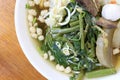 Vietnamse noodle soup, served with fresh herbs at the buddhist eatery, radish, morning glory, shiitake and tofu in white bowl on W Royalty Free Stock Photo