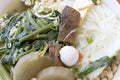 Vietnamse noodle soup, served with fresh herbs at the buddhist eatery, radish, morning glory, shiitake and tofu in white bowl on W