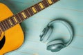 View from above of acoustic guitar and green headphones Royalty Free Stock Photo