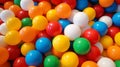 View from above of a ball pool filled with numerous plastic balls in various colors at a kids\' indoor playground. notion for