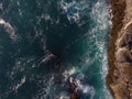 View from above. Beautiful seascape. Bubbling ocean water with white foamy waves and the edge of a rocky shore. Ecology, geology, Royalty Free Stock Photo