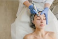 View from above of beautiful woman enjoying cosmetology procedures, rejuvenation in beauty salon. Dermatology, doctor at Royalty Free Stock Photo