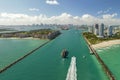 View from above of big container ship entering main channel in Miami harbor near South Beach high luxurious hotels and Royalty Free Stock Photo