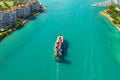 View from above of big container ship entering main channel in Miami harbor near South Beach high luxurious hotels and Royalty Free Stock Photo