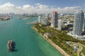 View from above of big container ship entering main channel in Miami harbor near South Beach high luxurious hotels and Royalty Free Stock Photo
