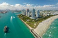 View from above of big container ship entering main channel in Miami harbor near South Beach high luxurious hotels and Royalty Free Stock Photo