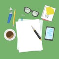 View from above of blank sheets of paper, pen, pencil, marker, smart phone, a notebook, stickers, glasses, coffee cup. Royalty Free Stock Photo