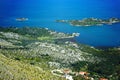 A view from above on a blue lake near the mountain, islands and wetlands, a Muslim mosque in a small village on the mountain Royalty Free Stock Photo