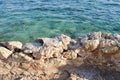 View from above of the blue sea, water with a coral bottom with a stone old ancient crumbling wall